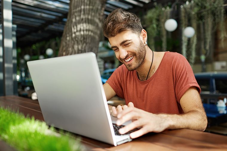 cheerful-handsome-man-talking-with-friend-online-typing-on-laptop-and-smiling-happy-1-1_opt