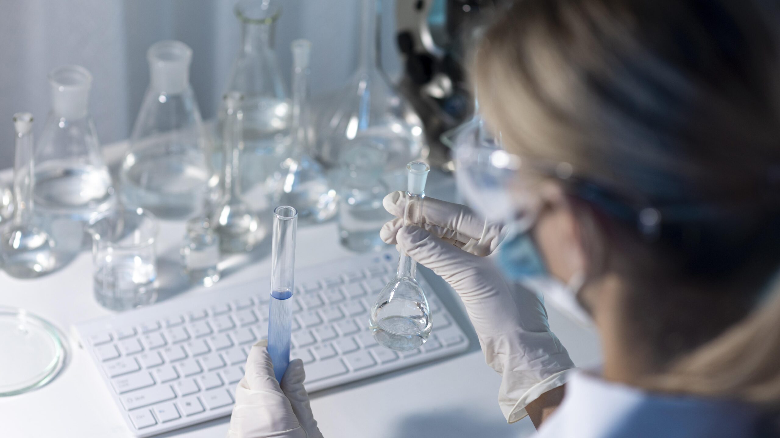 close-up-female-researcher-holding-glassware