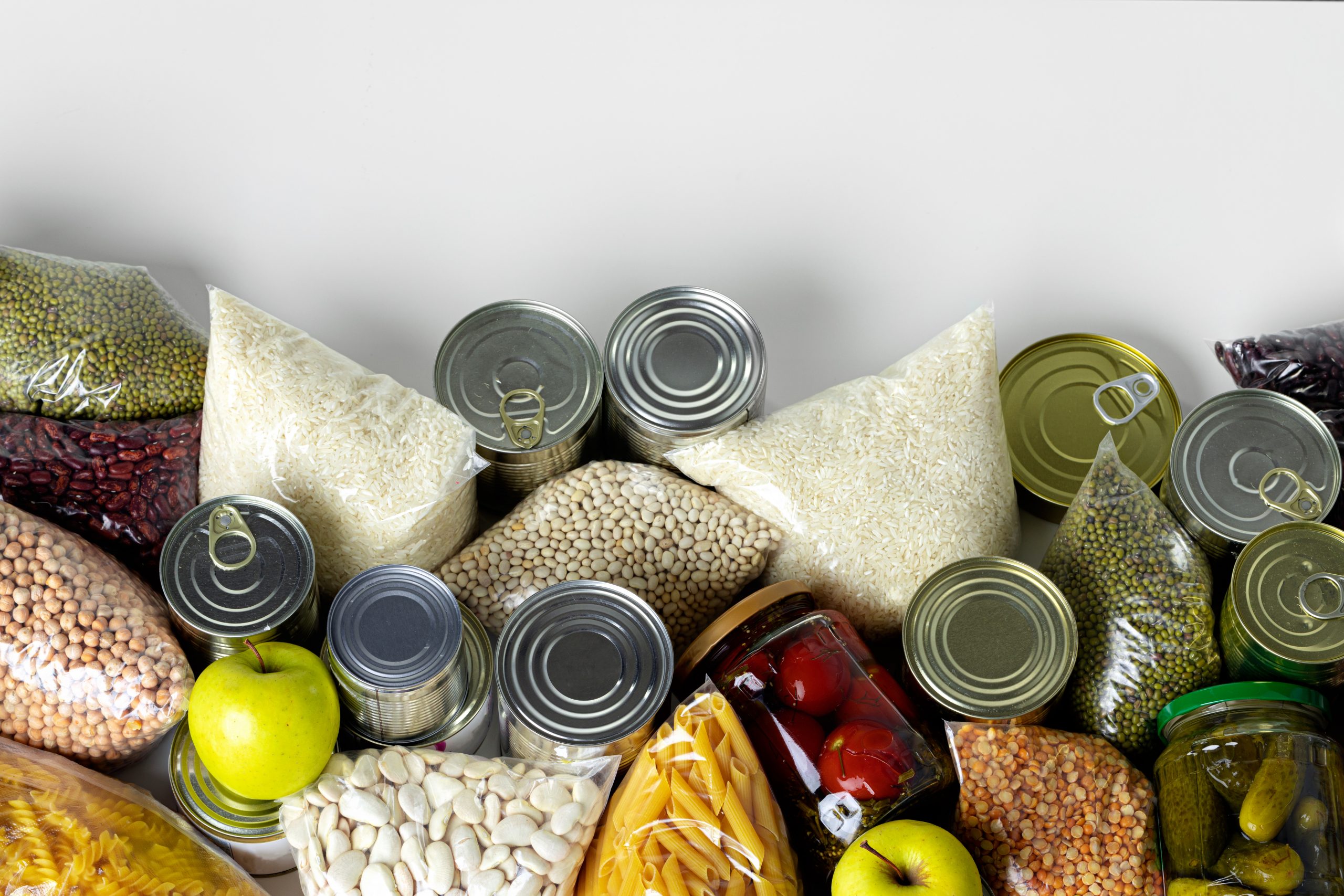Set of raw cereals grains pasta and canned food on the table